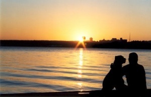 Man with Dog at Sunset by Water