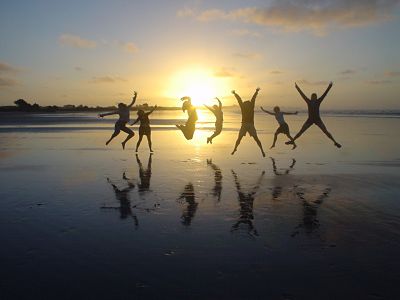 People Jumping on Beach