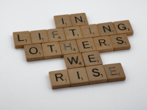 In Lifting Others We Rize